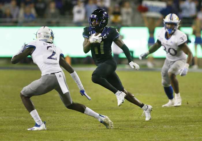Nov 20, 2021; Fort Worth, Texas, USA; TCU Horned Frogs wide receiver Derius Davis (11) runs after the catch as Kansas Jayhawks cornerback Jacobee Bryant (2) defebnds during the second half at Amon G. Carter Stadium.